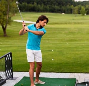 Portrait of a male golf player practicing